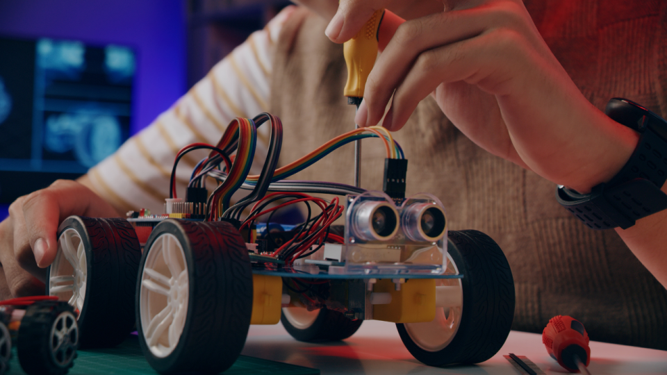 Student assembling a robot