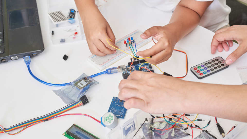 Two children working on an electronics project
