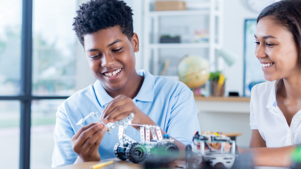 Boy and girl working with an erector set
